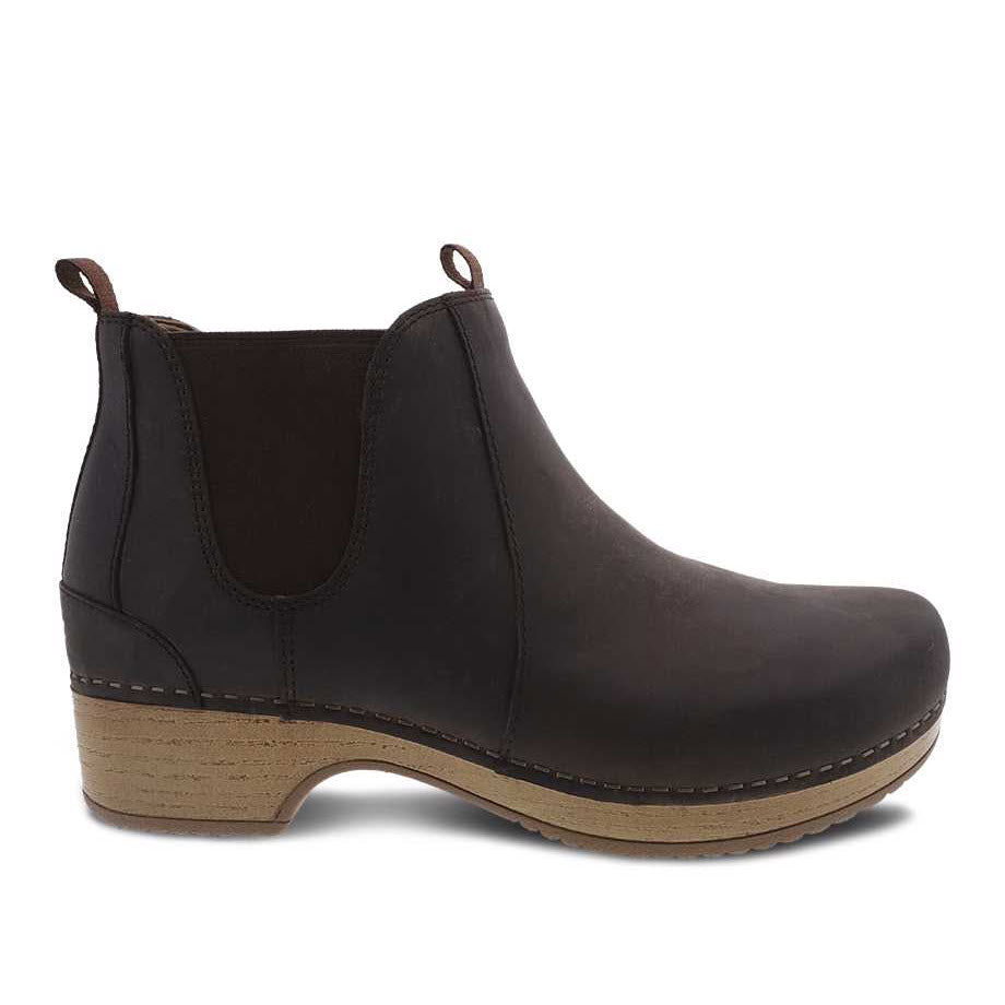 Side view of a Dansko Becka Brown leather chelsea boot with elastic side panels and a wooden sole, ideal for your fall/winter wardrobe.