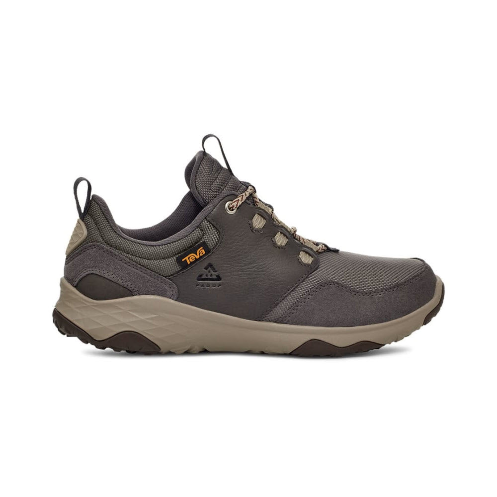 A single Teva hiking shoe with a beige, durable rubber outsole and lace-up front, featuring a logo on the side, displayed against a white background.