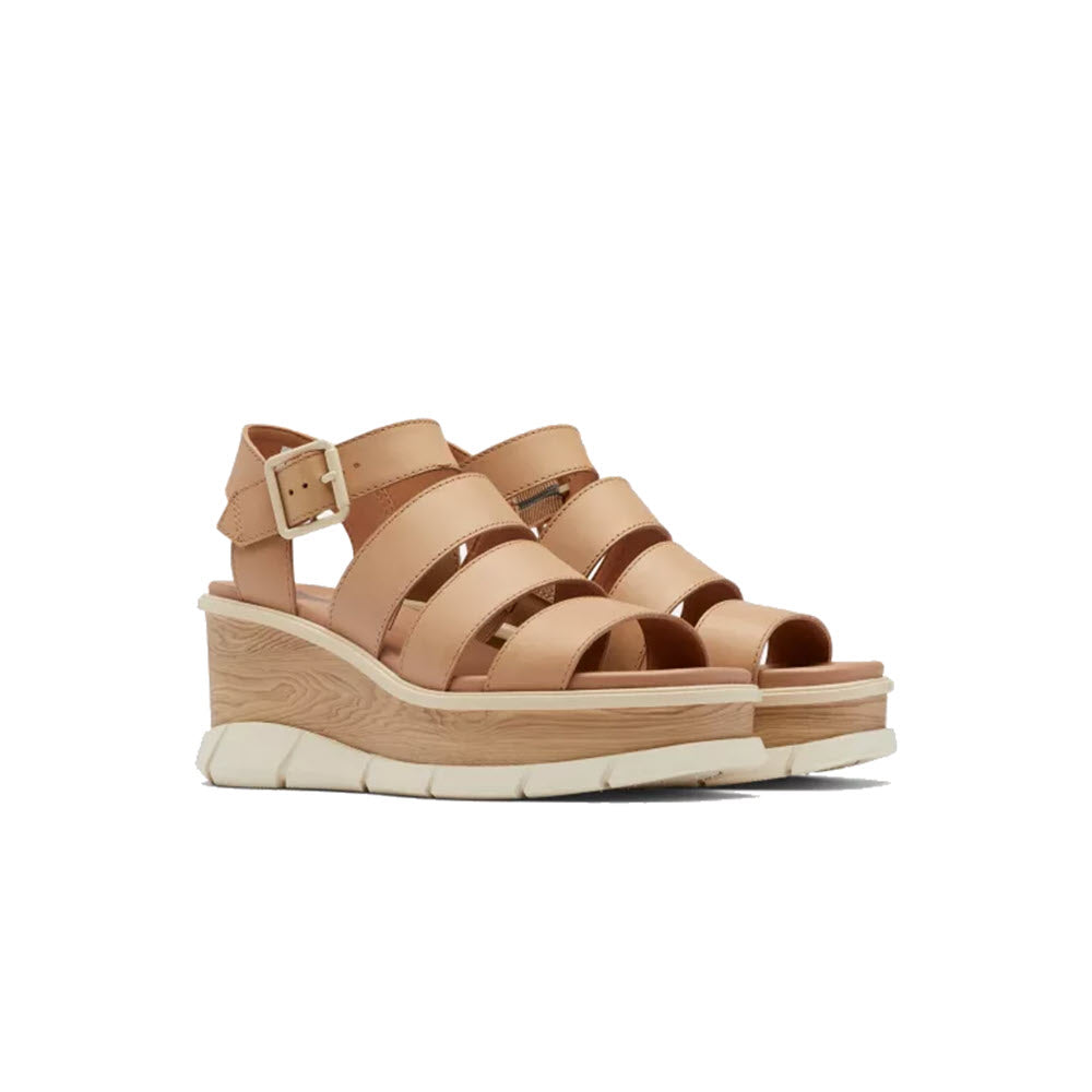 A pair of beige SOREL JOANIE III Ankle Strap sandals with multiple straps and a chunky white sole, displayed against a white background.