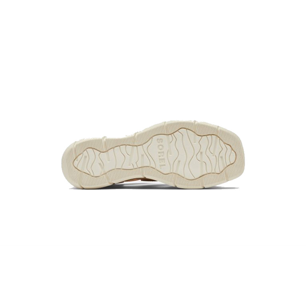 A plain, tan-colored SOREL JOANIE III ANKLE STRAP HONEST BEIGE - WOMENS sole with a high-traction rubber outsole displayed against a white background, with the brand name &quot;Sorel&quot; embossed near the heel.