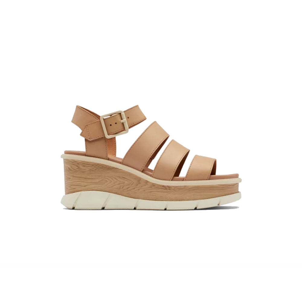 Beige SOREL Joanie III Ankle Strap platform sandal with a chunky wooden heel and buckle closure, isolated on a white background.