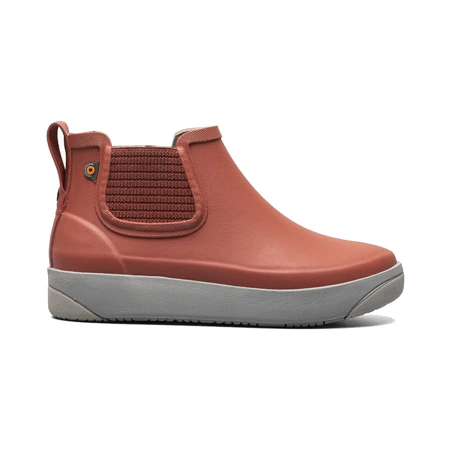 A single coral red Bogs Kicker Rain Chelsea II Ember boot with a thick gray sole and an elastic side panel.