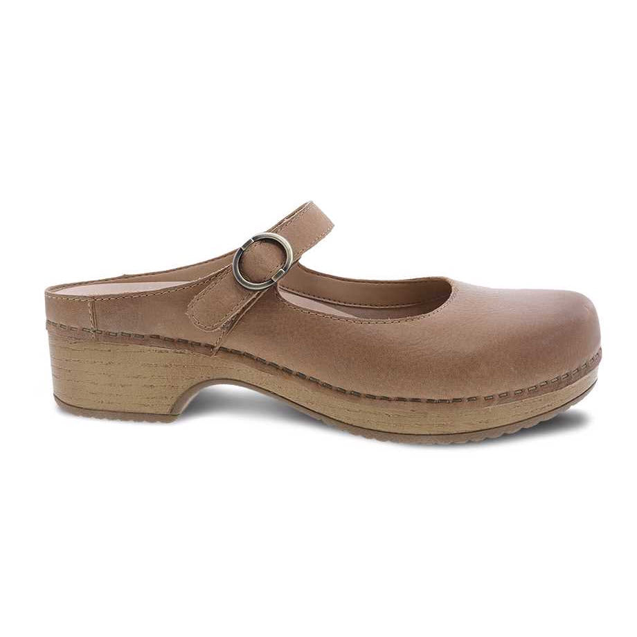 A single Dansko Bria Tan Nubuck - Womens clog with an adjustable strap and a wooden platform sole, featuring stain resistance, isolated on a white background.