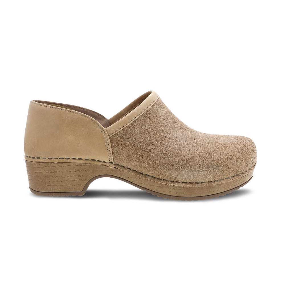 A beige leather slip-on clog shoe with a chunky heel and stitching details, isolated on a white background. 
Product Name: DANSCO BRENNA SAND SUEDE - WOMENS
Brand Name: Dansko