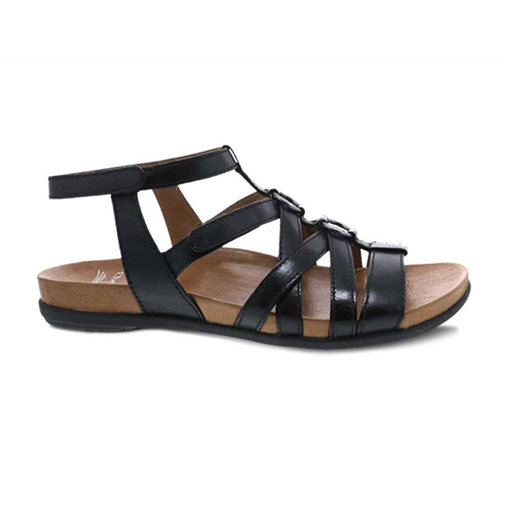 Dansko Jolene black glazed gladiator sandal with a low heel and a supportive insole, displayed against a white background.