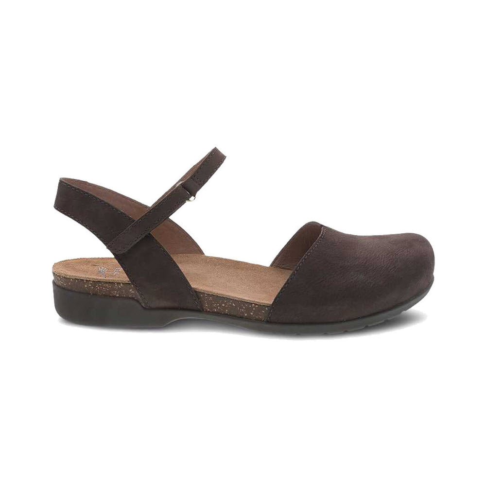 A brown leather Dansko Rowan sandal with a closed toe, ankle strap, and a small wedge heel, isolated on a white background.
