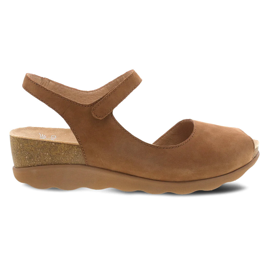 A single brown Dansko Marcy Tan Nubuck sandal with a cork platform heel and an adjustable ankle strap, displayed against a white background.