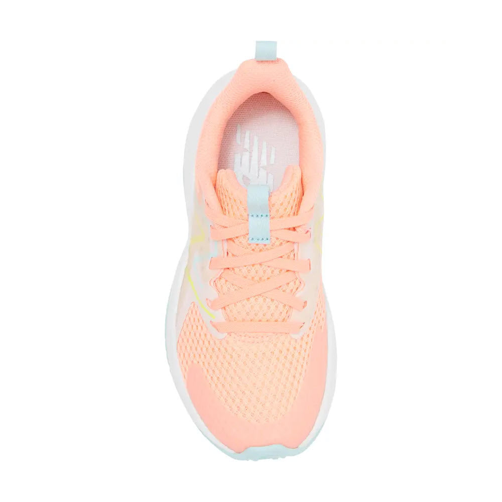 Top view of a New Balance Rave Run 2 Grapefruit kids’ running shoe with pink and white coloring, light blue accents, and laces on a white background.