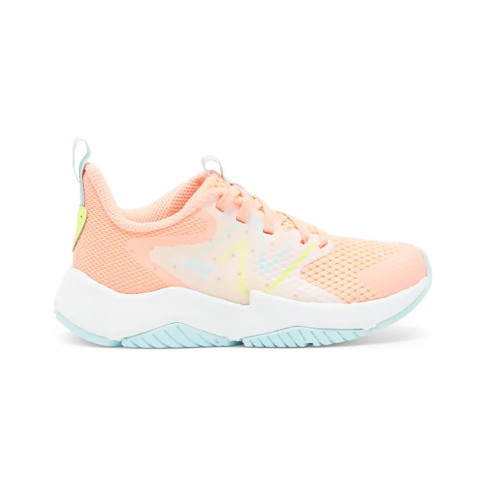 A pastel pink and blue New Balance Rave Run 2 Grapefruit kids’ running shoe with breathable mesh fabric and chunky white soles, displayed against a white background.