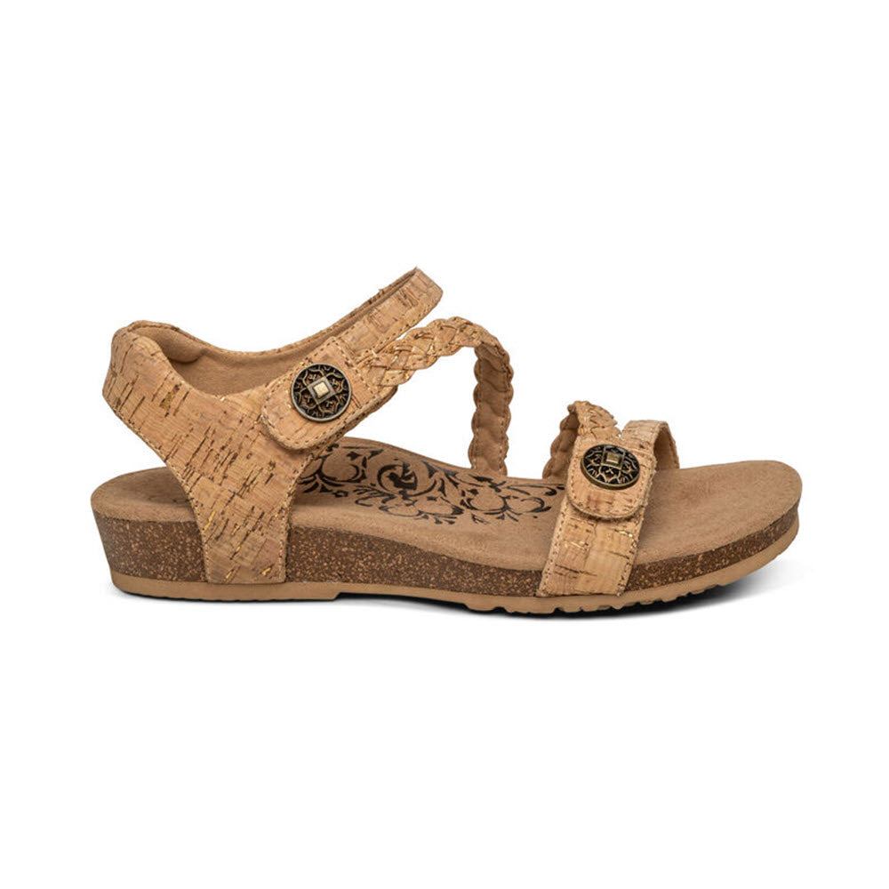 A AETREX JILLIAN CORK - WOMENS sandal with braided straps, Aetrex Signature Arch Support, and decorative metal accents, isolated on a white background.