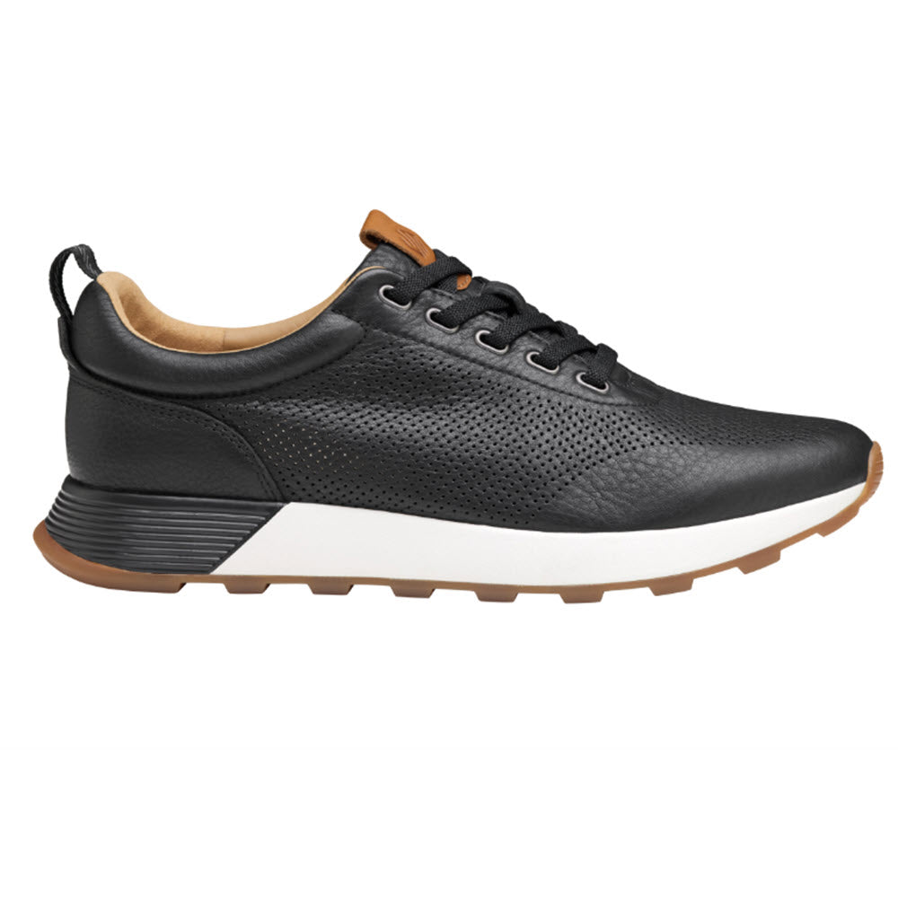 Johnston & Murphy Kinnon Pered Jogger Black sneaker with perforated detailing, a contrasting white TRUFOAM cushioning sole, and brown leather accents on the heel.