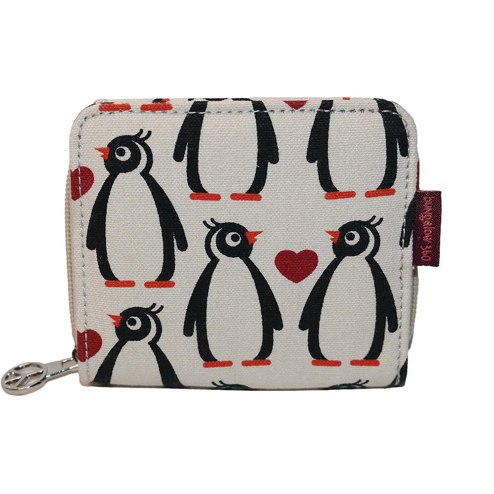 A small Bungalow 360 Billfold Wallet Penguin featuring a pattern of black and white penguins and red hearts on a cream background, with a metal zipper and a brand tag.