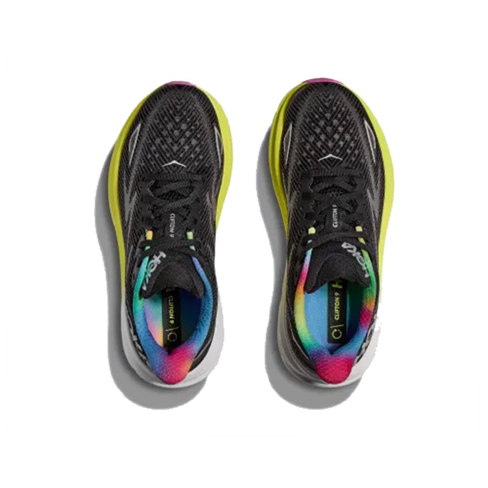 A pair of Hoka Clifton 9 Black/All Aboard - Womens running shoes with vibrant rainbow insoles, featuring an improved outsole design, viewed from above.