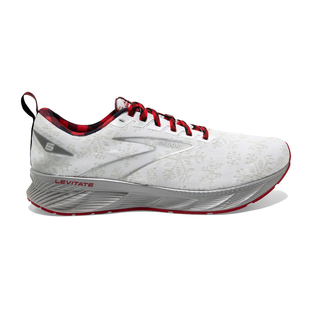 White and gray Brooks Levitate 6 Christmas White/Red/Silver running shoe with red laces and an arrow-point outsole on a white background.