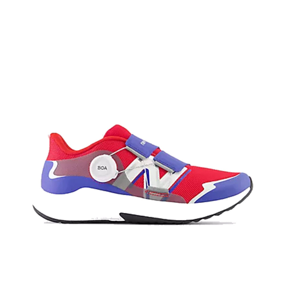 A New Balance red and blue athletic shoe with white velcro straps and purple accents, featuring a BOA® Fit System on the side.