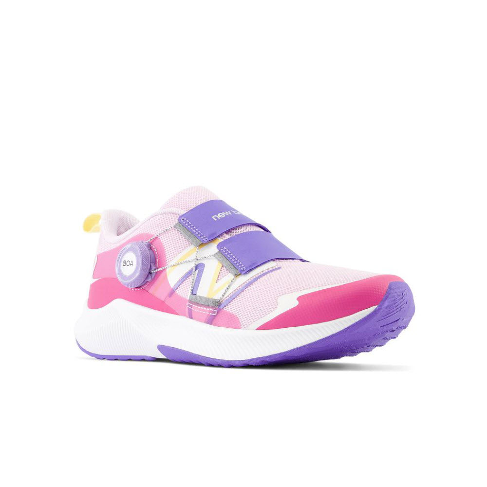 A New Balance kids&#39; sneaker featuring pastel pink and purple shades with a white sole and BOA® Fit System.