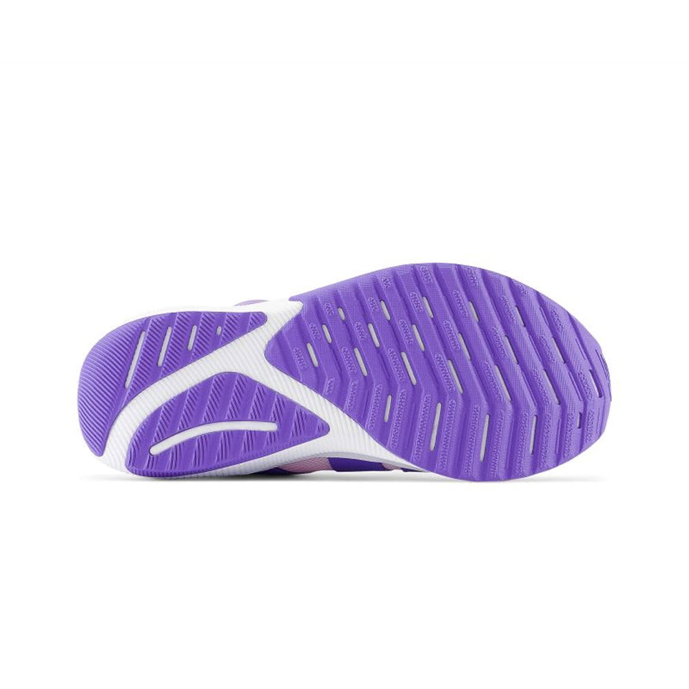 Purple and white rubber sole of a New Balance Revea V4 Boa Light Raspberry - Kids sneaker with a grippy tread pattern, photographed on a white background.