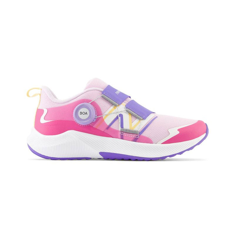 A pink and white New Balance kids&#39; sneaker with a BOA® Fit System closure and purple accents on a white background.