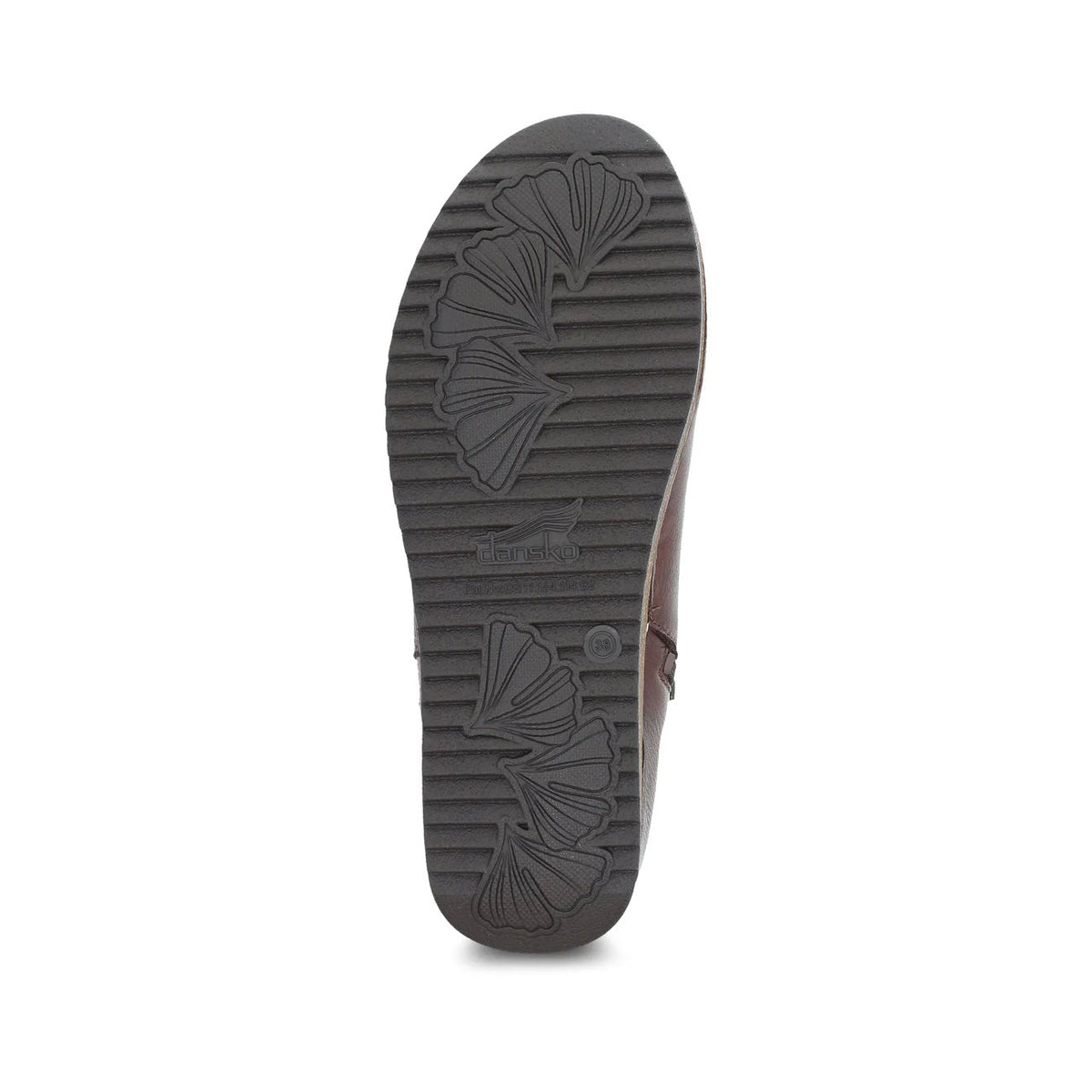 Bottom view of a single Dansko Makara bootie showing tread pattern with floral designs and the Dansko logo visible.