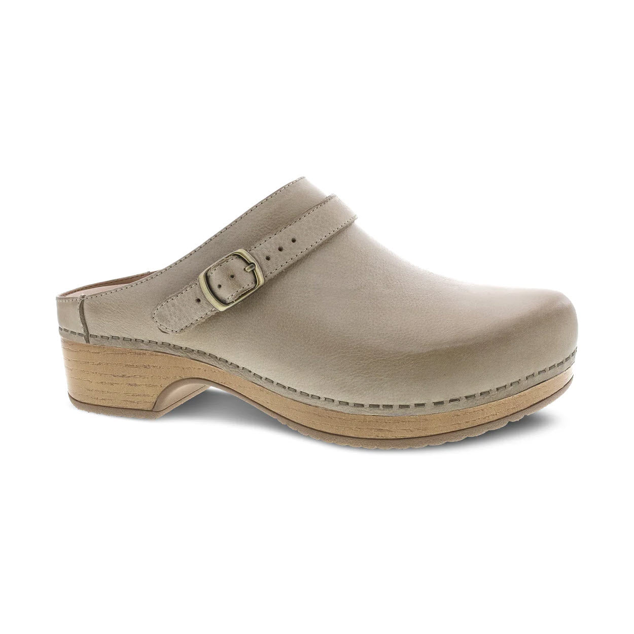 A Dansko beige leather mule with a wooden sole and a buckle on the side, isolated on a white background.