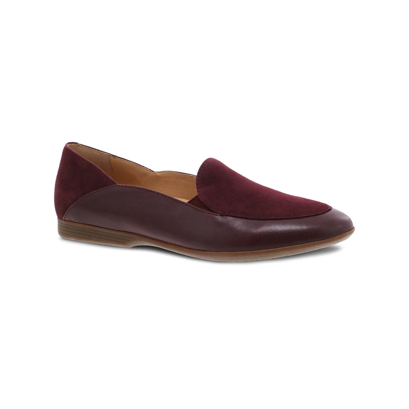 A burgundy Dansko lace wine glazed women's loafer featuring a velvety upper and a smooth, buttery soft leather toe, displayed against a white background.