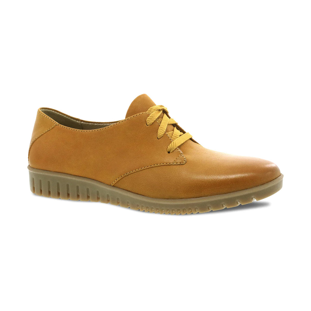 A single Dansko Libbie Mustard Burnished Oxford shoe with white rubber sole, isolated on a white background.