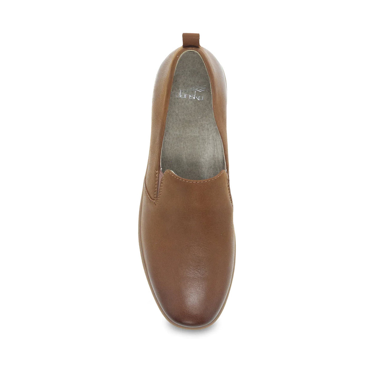 Top view of a single Dansko Linley tan burnished slip-on shoe with a molded arch shape on a white background.