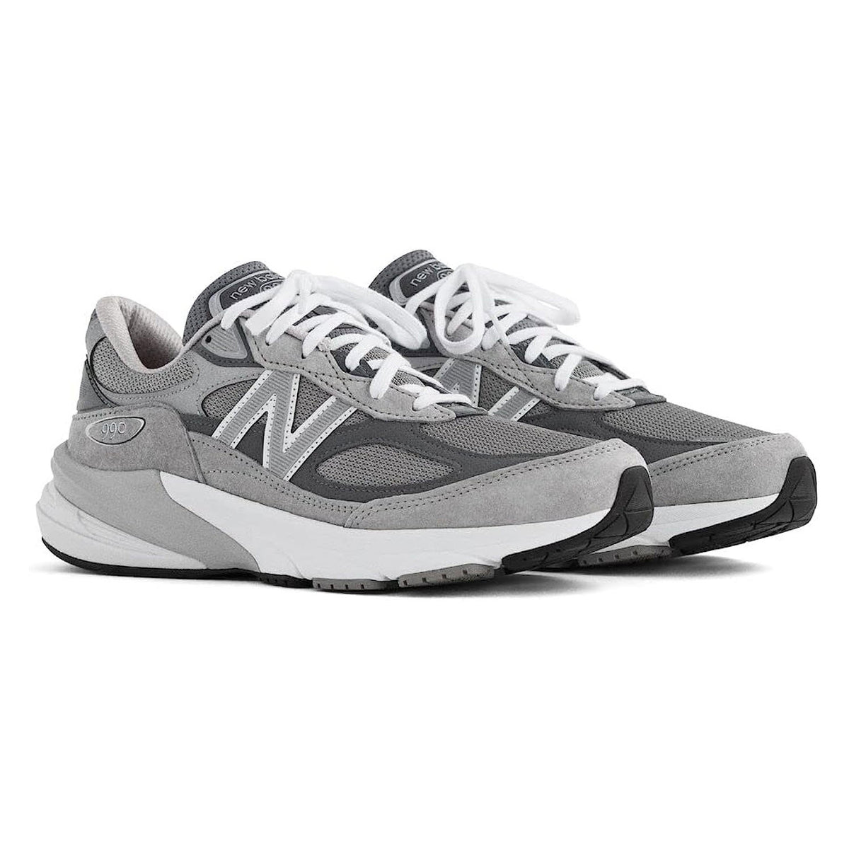 A pair of NEW BALANCE 990 V6 GREY - MENS sneakers in gray, showcasing a prominent &quot;N&quot; logo and ENCAP midsole cushioning, displayed side by side on a white background.