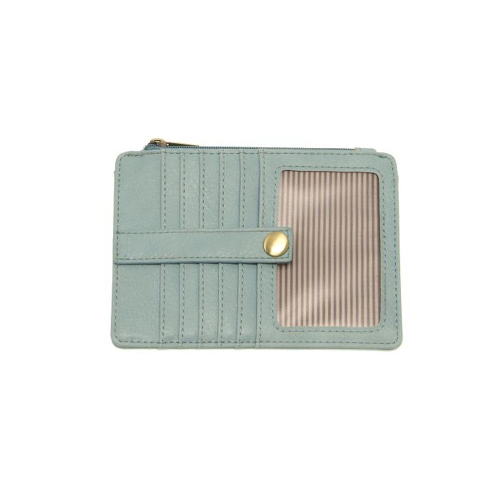 Sentence with replacement: Light blue vegan leather JOY NEW PENNY MINI WALLET BLUE SUGAR with a vertical card holder and a golden snap button closure, isolated on a white background by Joy Susan.