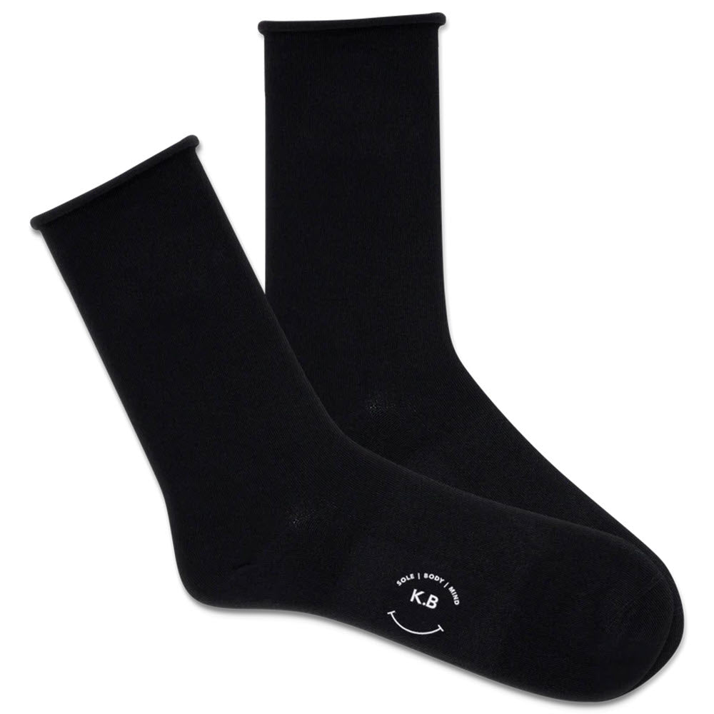 A pair of K BELL SOLID MODAL ROLL TOP BLACK crew socks with a smooth toe seam and white logo text at the toe area on a plain background.