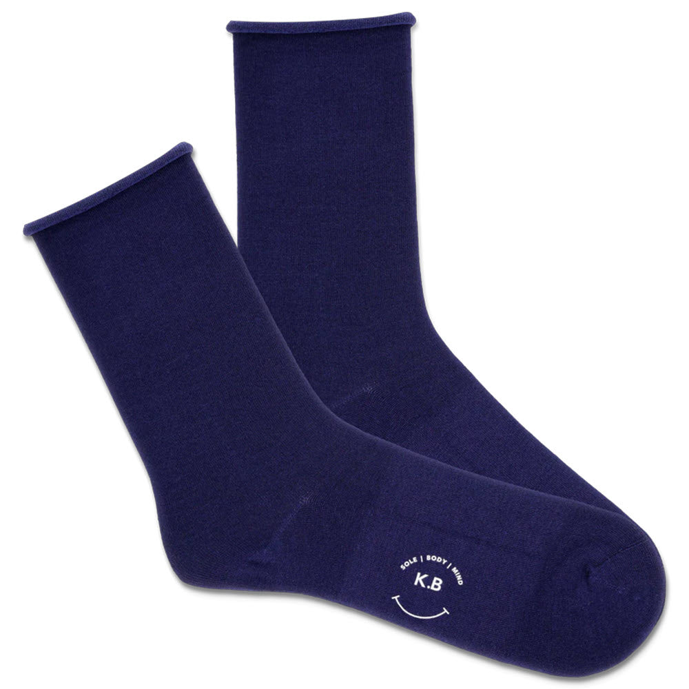 A pair of K. Bell Socks royal blue socks with a smooth toe seam and a white logo on the sole, displayed on a white background.
