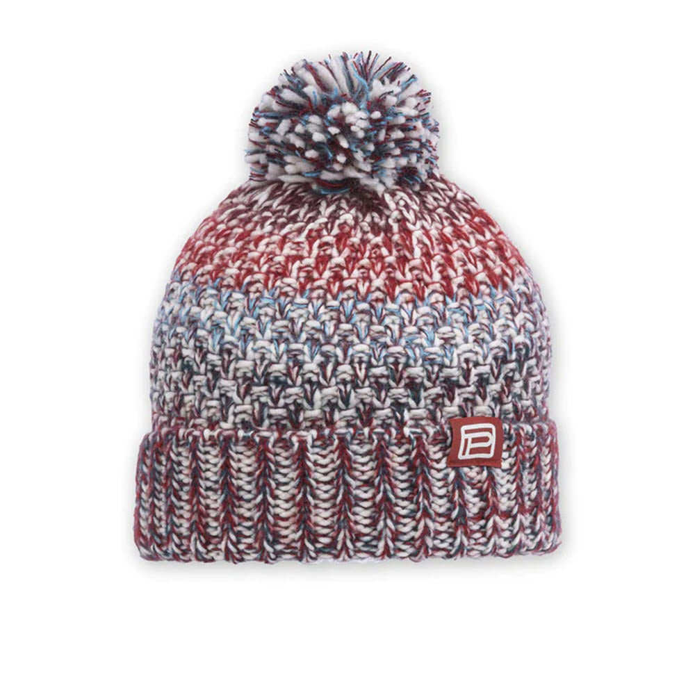 A multicolored women's Pistil Poppy hat in garnet with a pompom on top and a logo on the front, displayed against a white background.