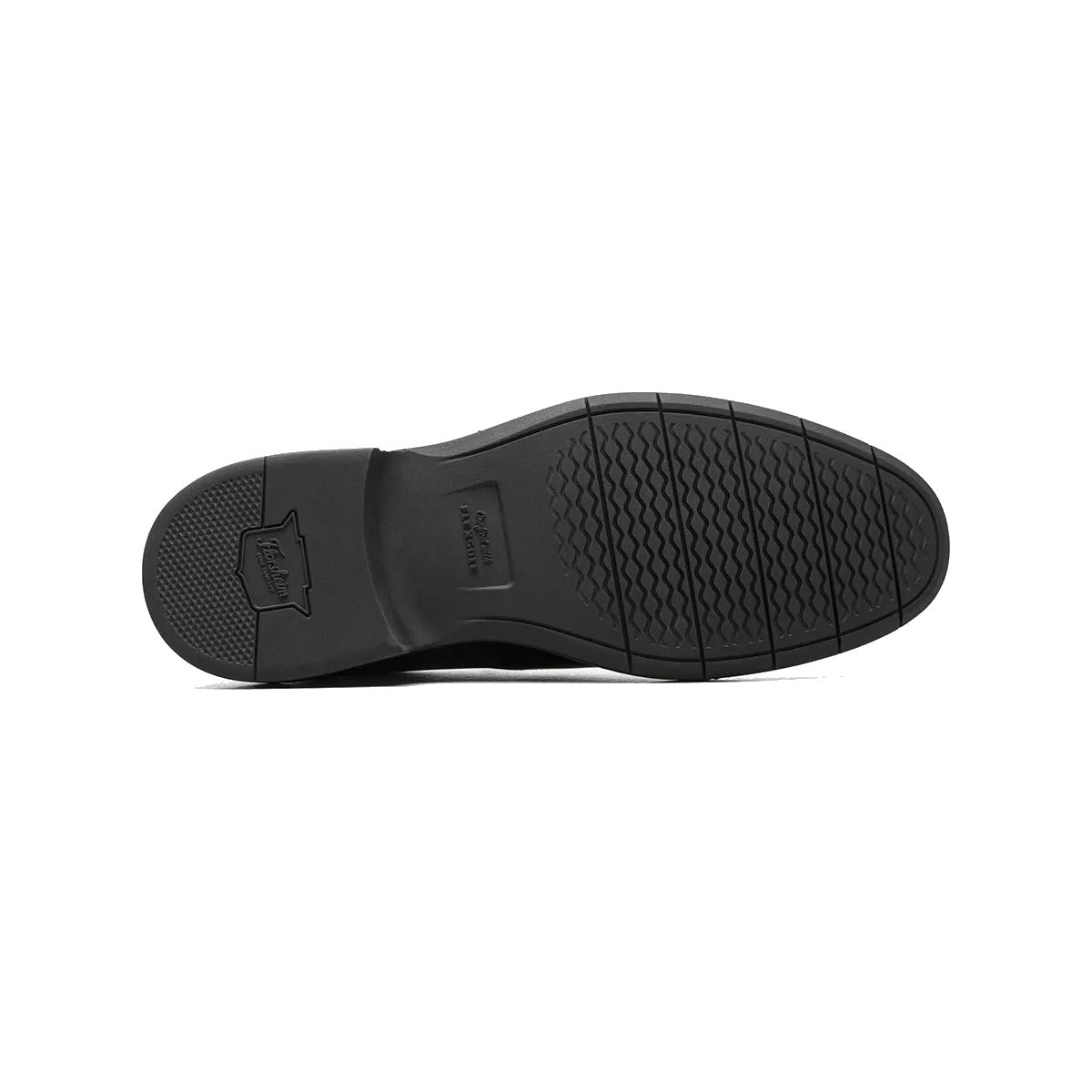 Black rubber sole of a shoe with textured tread and embossed Florsheim Norwalk Moc Toe Slip On Black - Mens logo.