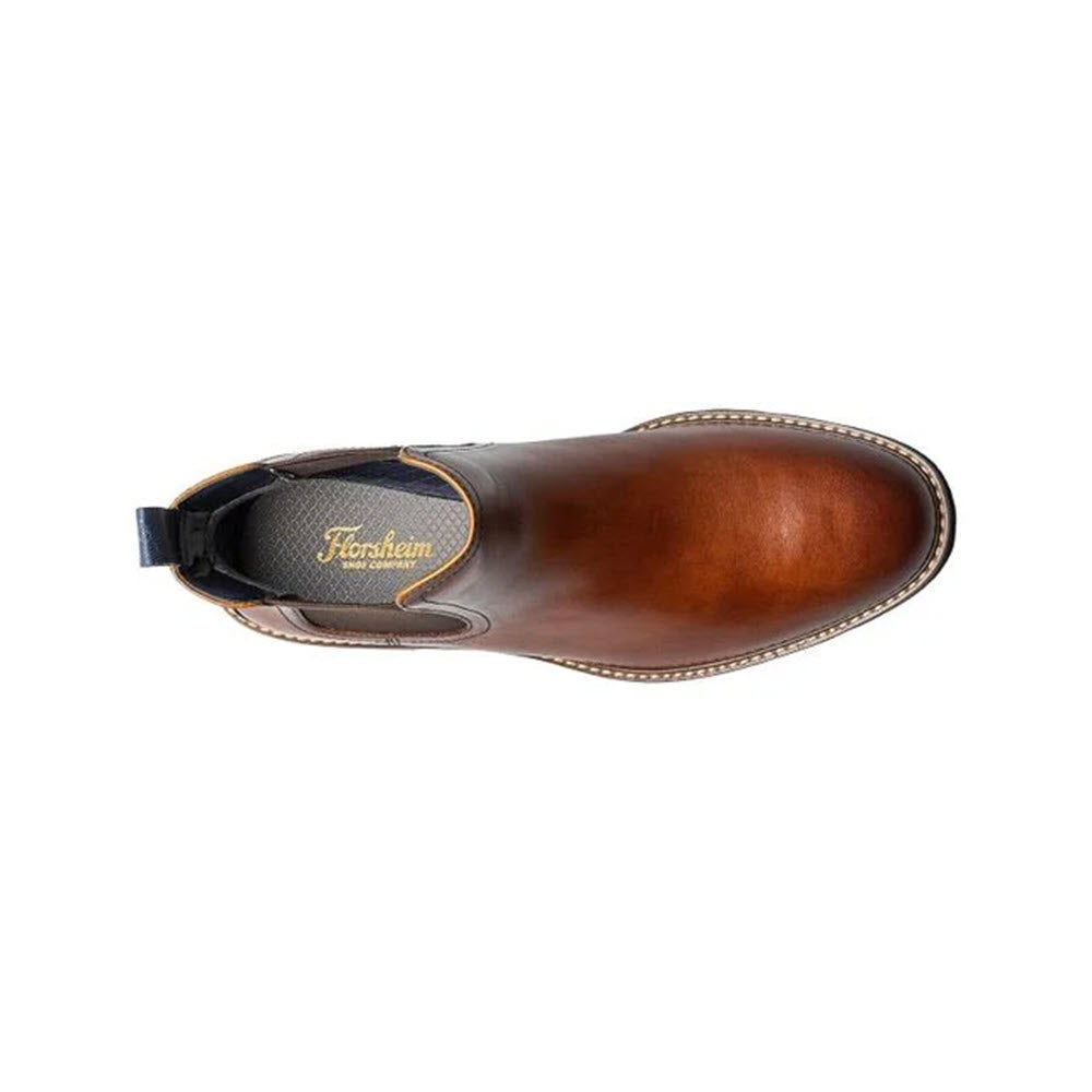 Top view of a single Florsheim Renegade Plain Toe Gore Cognac men&#39;s leather chelsea boot with a lug sole against a white background.