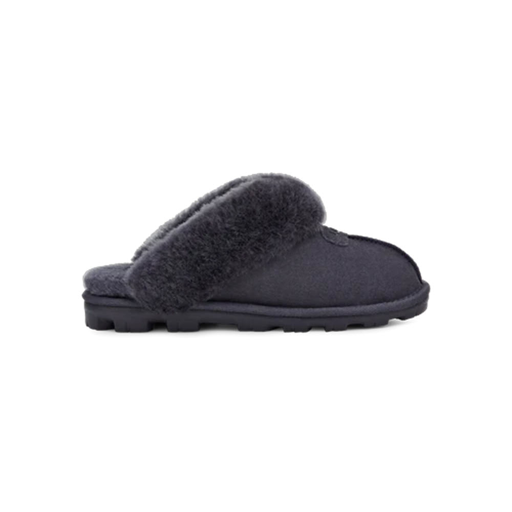 A single charcoal gray fluffy UGG Coquette Eve Blue house slipper with a thick sole, displayed against a white background.
