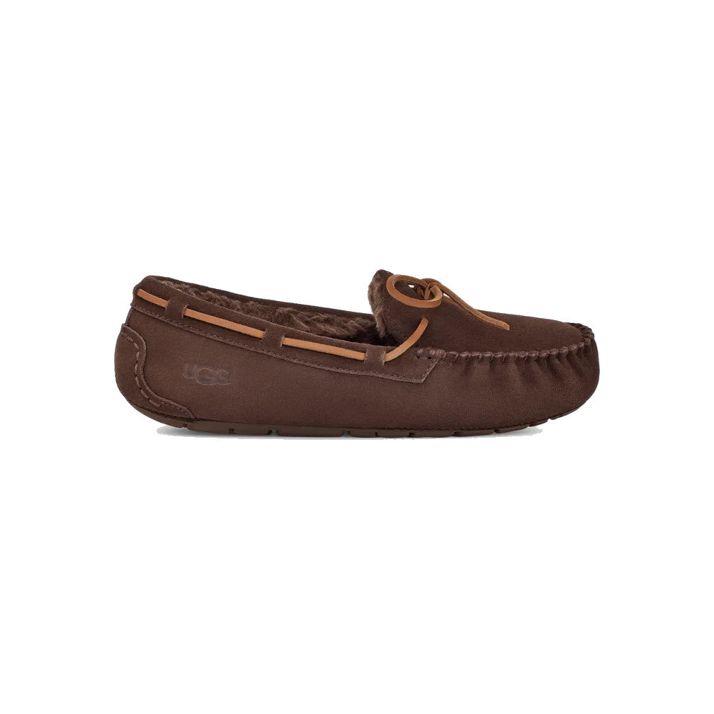 A single brown UGG Dakota slipper with a leather lace, visible stitching, and a rubber sole on a white background.