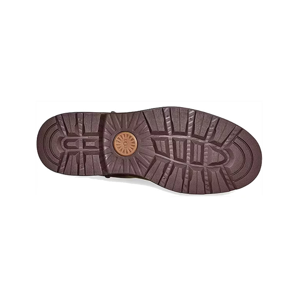 Sole of a Brown UGG BILTMORE Waterproof Chelsea Stout - Mens boot, displaying its tread pattern and a small circular logo at the center.