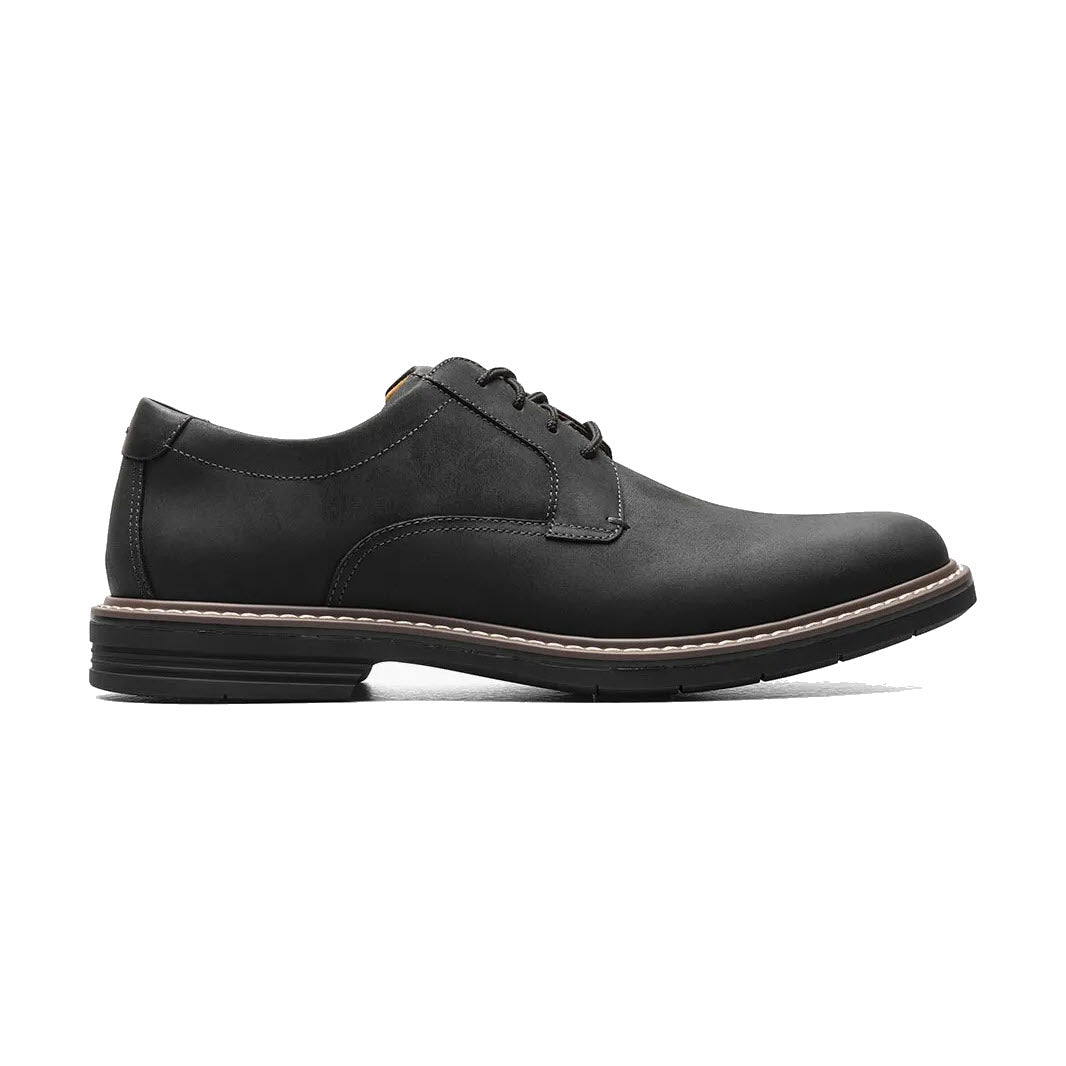 A single black leather Florsheim Norwalk Plain Toe Crazy Horse Black men's dress shoe with laces, featuring a low heel and tan stitching, displayed against a white background.