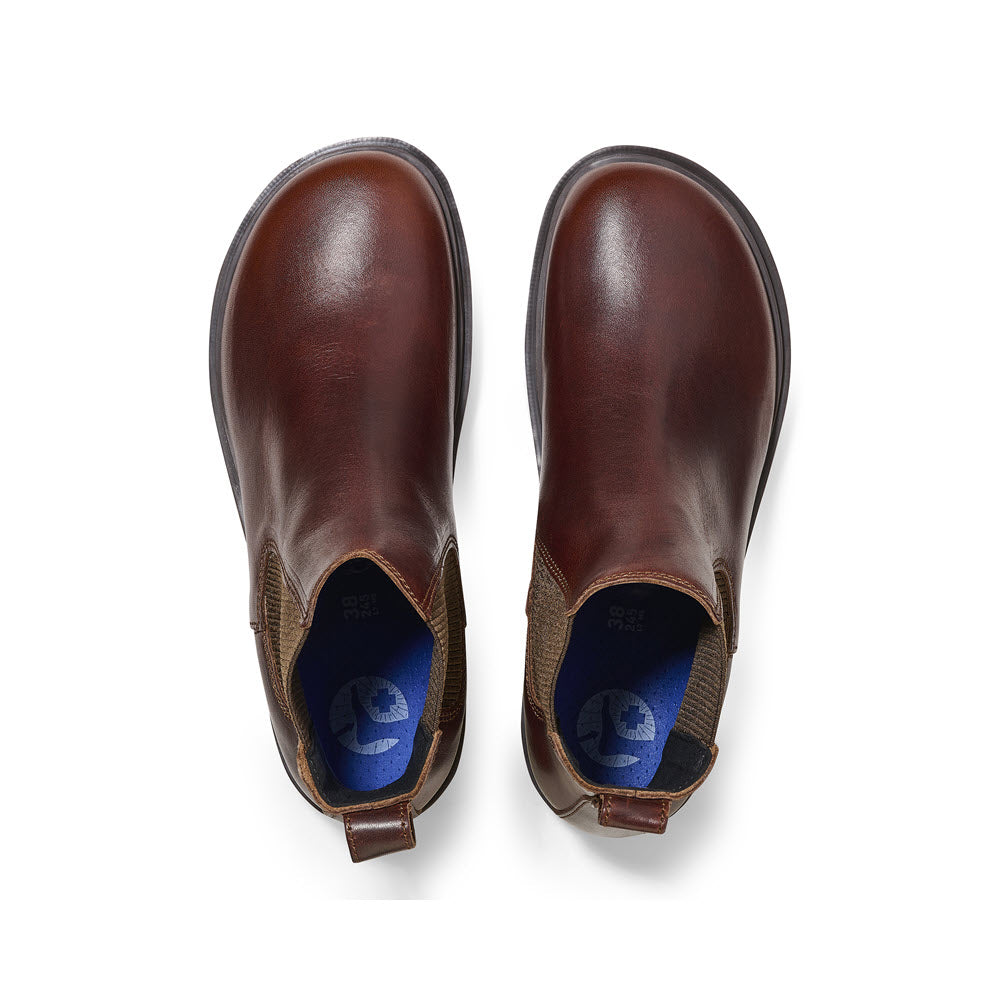 A pair of Birkenstock Highwood Deep Blue Chocolate women&#39;s Chelsea boots viewed from above, featuring elastic side panels and pull tabs on the heels.