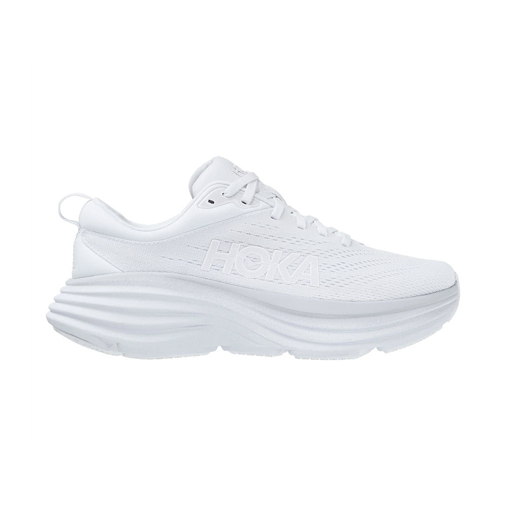 Sentence with replacement:
Side view of a white HOKA BONDI 8 WHITE/WHITE - WOMENS sneaker with a thick, layered sole and the Hoka brand name embossed on the side.