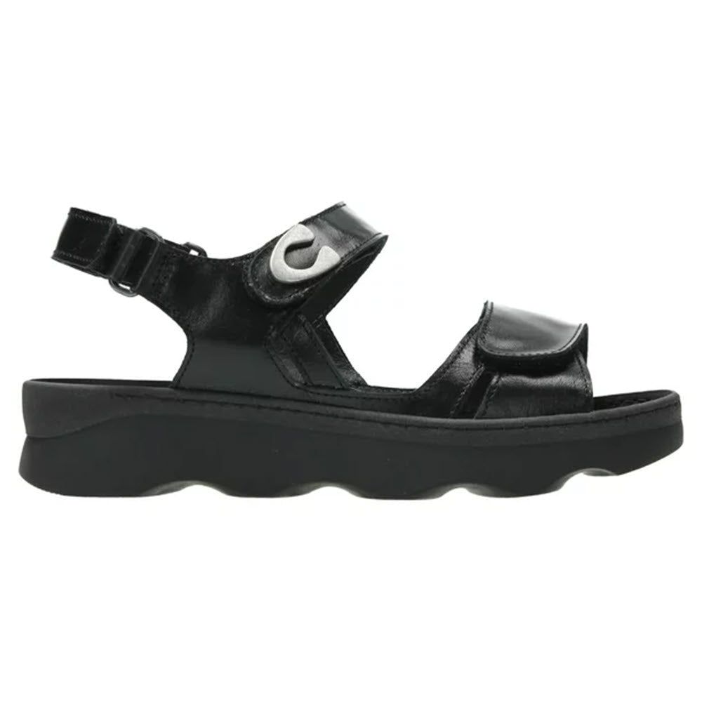 Wolky Medusa Black walking sandal with adjustable velcro straps and a lightweight rubber sole, isolated on a white background.