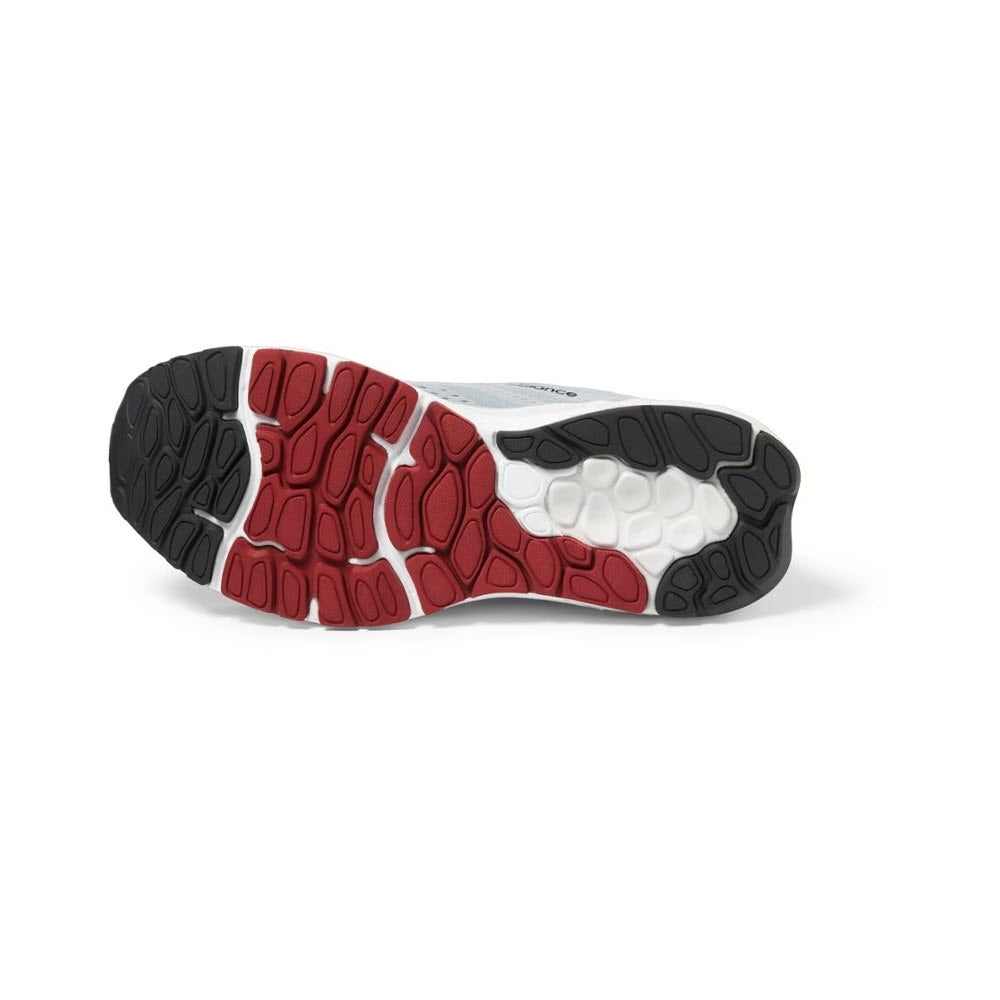 Sole of a New Balance running shoe featuring an NDurance rubber outsole with a red, black, and white tread pattern on a white background.