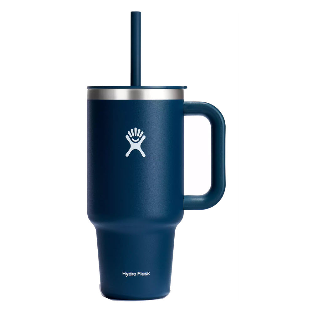 Navy blue Hydro Flask travel tumbler with a handle and a straw, featuring the brand's logo on the front.