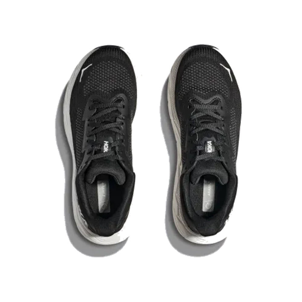 A pair of black and white HOKA Arahi 7 running shoes viewed from above on a white background.