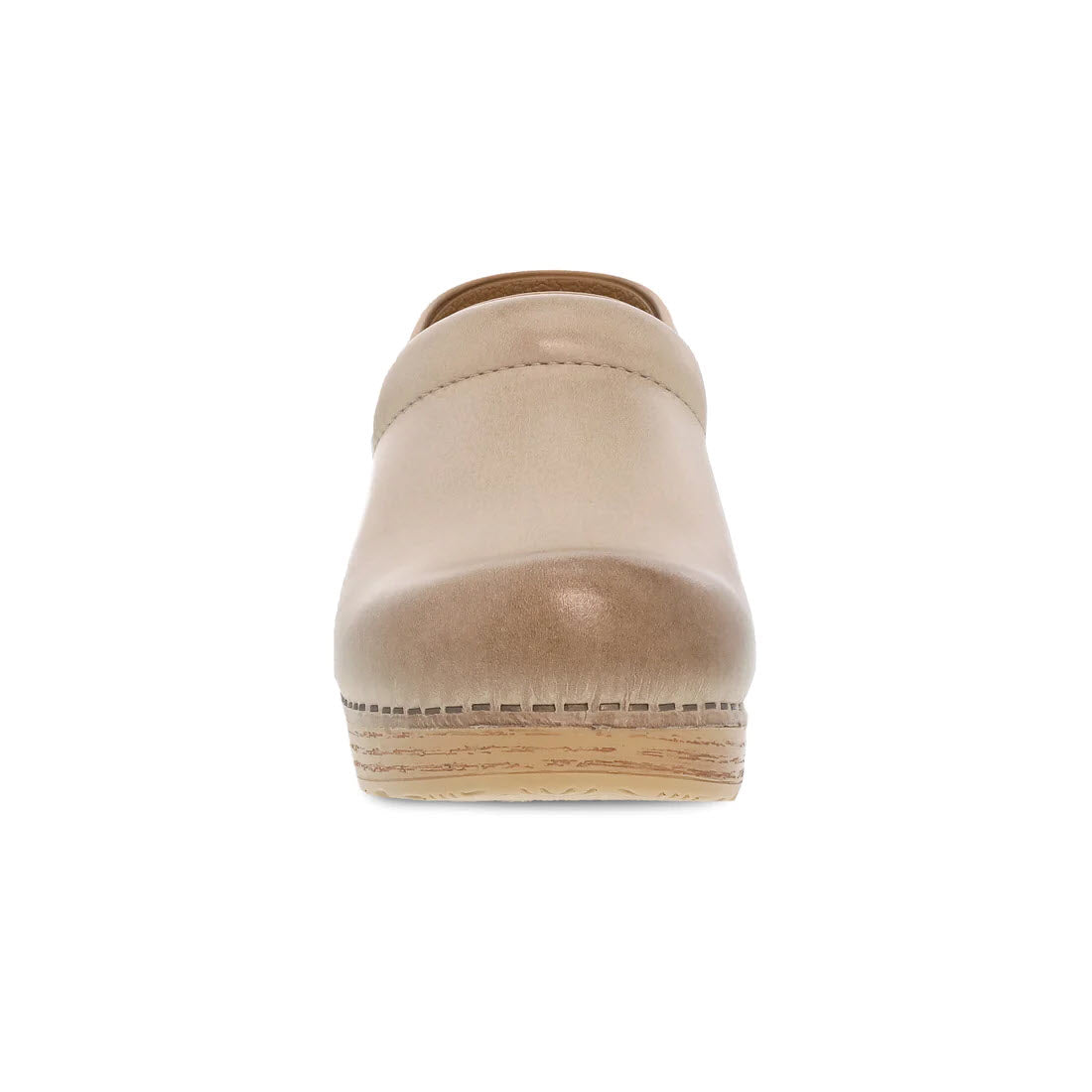 Front view of a beige leather Dansko Professional Sand Milled clog with cork detailing on the sole and an anti-fatigue rocker bottom.