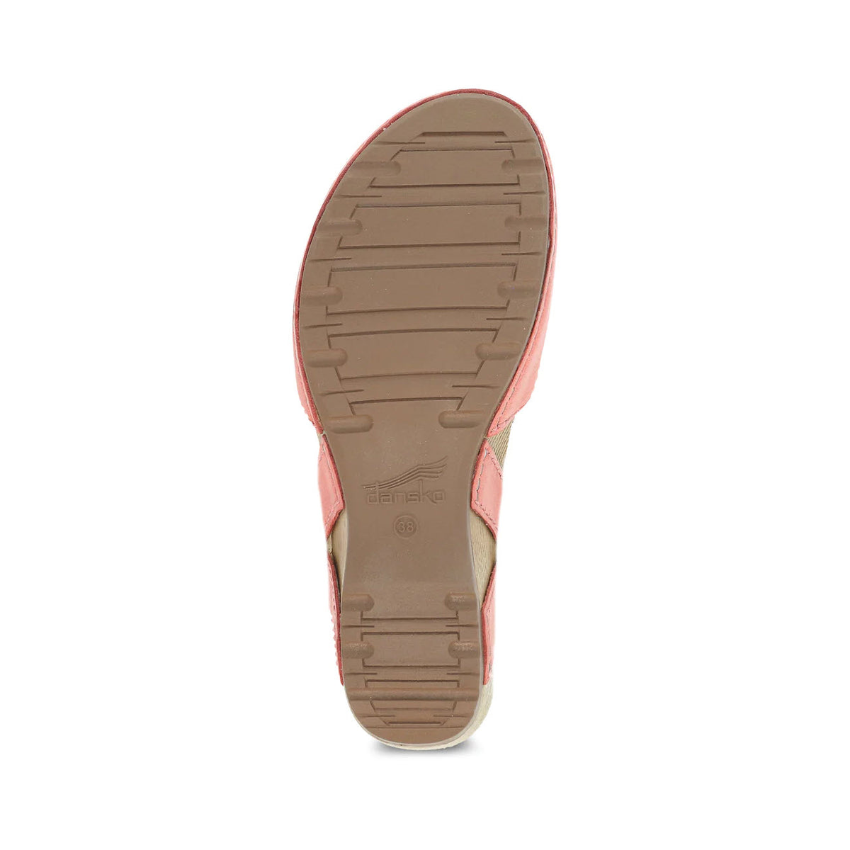 A single closed toe sandal sole facing upward, featuring a tan and brown color scheme with textured treads and visible Dansko branding.