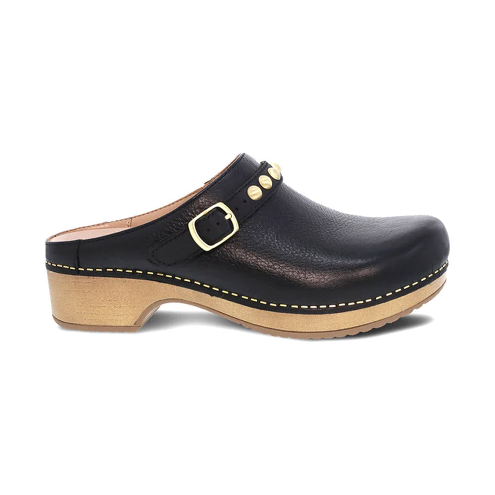 Dansko Britton black leather mule with silver hardware on a wooden sole, isolated on a white background.
