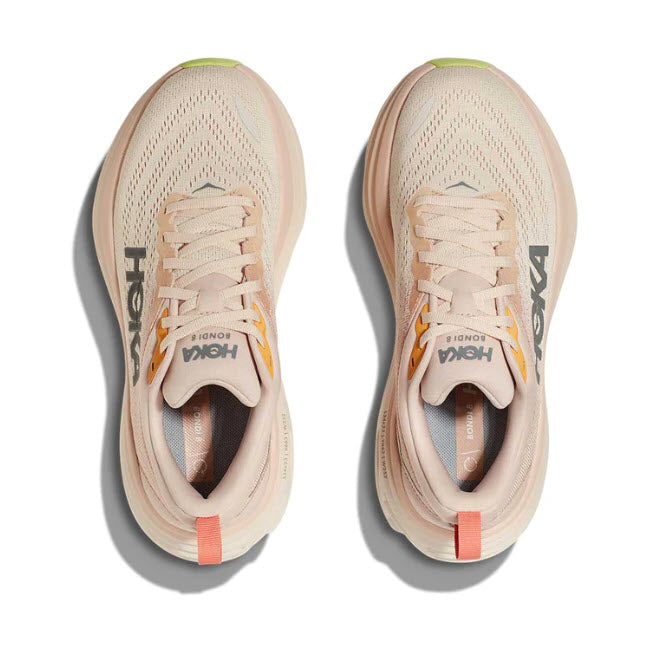 A pair of beige Hoka Bondi 8 Cream/Vanilla running shoes with the brand logos visible, laid flat and symmetrically.