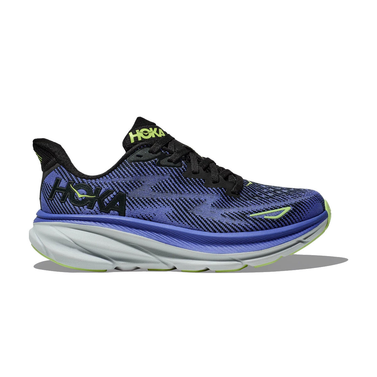 A Hoka CLIFTON 9 BLACK/STELLAR BLUE - WOMENS running shoe, featuring a black and blue patterned upper and a thick, white sole with an improved outsole design.