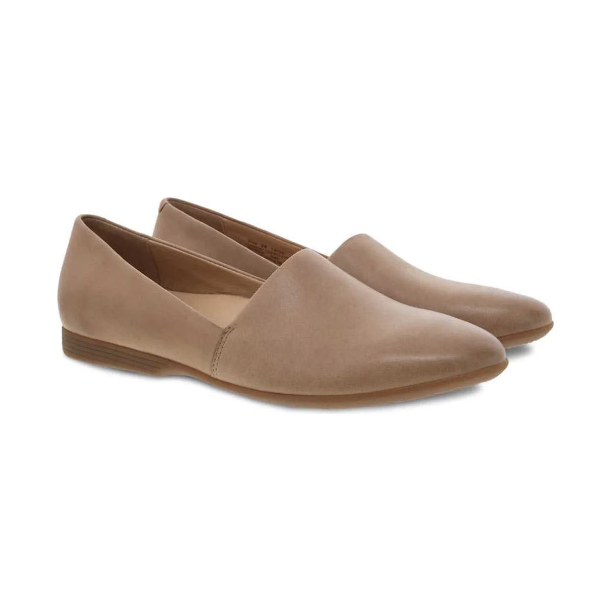 A pair of beige Dansko Larisa Taupe slip-on flats with memory foam cushioning on a white background.